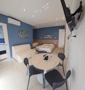 a living room with a table and a couch at Althea B&B in Schiavonea