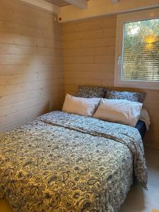 a bed in a small room with a window at Californian style chalet in Gassin +17 photos