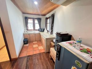 a small kitchen with a counter and a refrigerator at Rockgarden Beach Resort in Mae Pim