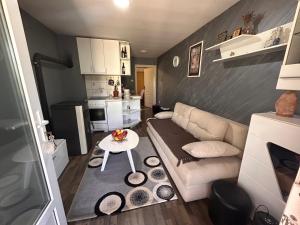 a small living room with a couch and a table at Vikendica Aurora in Šabac