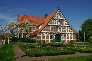 a large house with a garden in front of it at Diekstuv Hotel in Jork