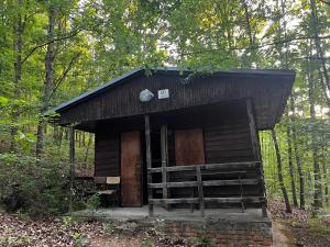 a small building in the middle of the woods at Basecamp Brno in Brno