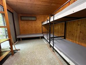 an empty room with two bunk beds in it at Basecamp Brno in Brno