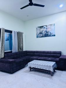 a living room with a couch and a coffee table at Ashirwad Niwas in Bokāro