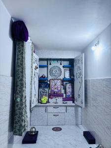 a kitchen with a cupboard filled with lots of dishes at Ashirwad Niwas in Bokāro