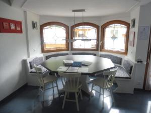 a dining room with a table and chairs at Apartment Theresli First Floor in Saas-Almagell +11 photos