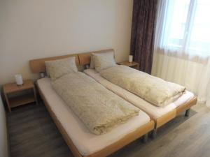 two pillows on a bed in a room at Apartment Theresli First Floor in Saas-Almagell