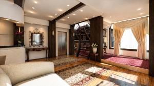 a living room with a couch and a staircase at BaB Hotels and Apartments-Zum Letzten G'Stehr in Bad Rippoldsau