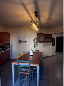 a kitchen with a dining room table with chairs at Le colline in corso Bra in Alba