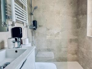 a bathroom with a sink and a shower at Santander suites and rooms atlántico in Santander
