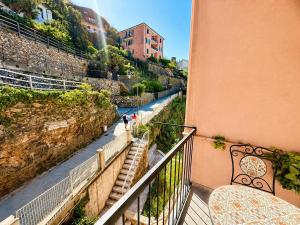a balcony of a building with a view of a river at Vertigini Suites, Il Rifugio dell Amore per SOLE COPPIE , A 50m dalla Stazione e dalla Via dell Amore con Vista Mare e Intimità Appagante in Riomaggiore