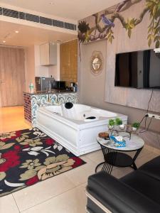 a large white tub in a living room at Nature Escape Jacuzzi Apartment in Gurgaon