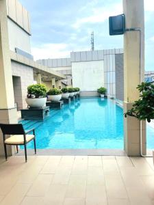 a large swimming pool on top of a building at Nature Escape Jacuzzi Apartment in Gurgaon