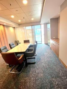 a conference room with a table and chairs in an office at Nature Escape Jacuzzi Apartment in Gurgaon +37 photos