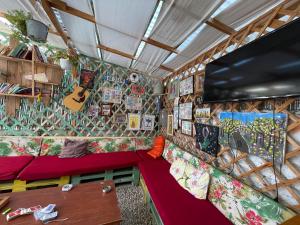 a living room with a couch and a flat screen tv at Vlora Backpackers Hostel & Bar LUNGOMARE in Vlorë