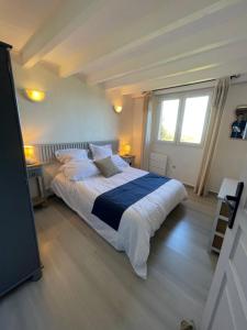 a bedroom with a large bed and a window at Charmante Maison Vue mer Panoramique à Coti-Chiavari in Coti-Chiavari +39 photos