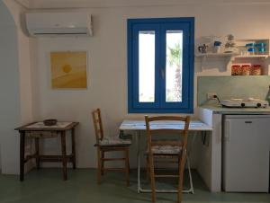 a kitchen with a table and chairs and a window at Dammusi Musa in Pantelleria +27 photos