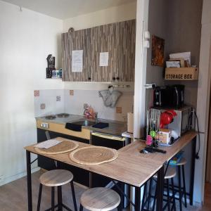 a small kitchen with a table and stools in it at Studio SAFARI in Luchon