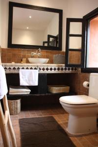 a bathroom with a sink and a toilet and a mirror at Villa Quince in Ouirgane +36 photos