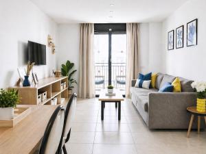 a living room with a couch and a table at Costa Suite Beach, Pool and Parking in Lloret de Mar