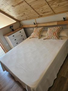 a large bed in a room with a wooden ceiling at Camping La Ribera Salada in Ogern +73 photos