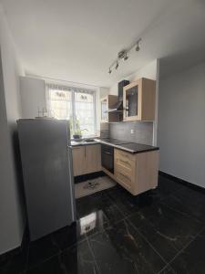 a kitchen with a sink and a counter at Escale à Villeneuve in Villeneuve-sur-Yonne