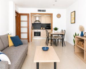 a living room with a couch and a table at Costa Suite Beach, Pool and Parking in Lloret de Mar