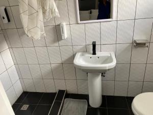a bathroom with a sink and a toilet at The Stone Duplex Apartment House 1 in Lilongwe +11 photos
