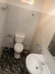 a bathroom with a toilet and a sink at kuma holiday resort in Meda-Ela
