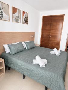 a bedroom with a bed with two towels on it at Costa Suite Beach, Pool and Parking in Lloret de Mar