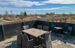 a table and chairs sitting on a patio at 2 Bedroom Stunning Home In Roslev in Roslev +13 photos