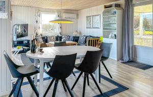 a dining room and living room with a table and chairs at 2 Bedroom Stunning Home In Roslev in Roslev