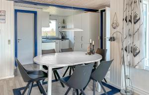 a kitchen and dining room with a table and chairs at 2 Bedroom Stunning Home In Roslev in Roslev