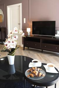 a living room with a coffee table and a tv at Downtown Apartments Podpromie Monica with UNDERGROUND PARKING in Rzeszów