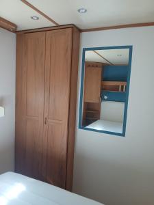 a bedroom with a mirror and a closet at Sosnowa Polana in Lipinki