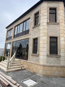 a building with glass windows and stairs in front of it at My_willa_Buzovna in Zağulba Bağları