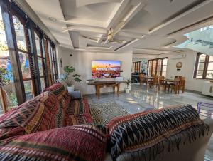 a living room with a couch and a pool table at Goa Paradise House in Canacona