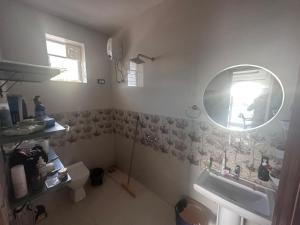a bathroom with a sink and a mirror at Goa Paradise House in Canacona +17 photos