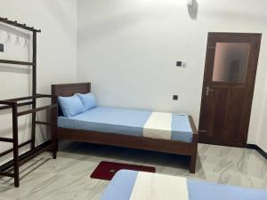 a bedroom with a bed and a bunk bed at Wagon Inns anuradhapura in Anuradhapura