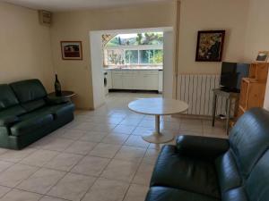 a living room with a couch and a table at Le Gite in Labastide-de-Virac