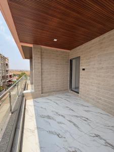 a balcony of a building with a wooden ceiling at Hotel Siyaram Inn in Trimbak