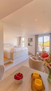 a bedroom with a bed and a living room at Le Semiramis l Central & Views l Shellter Rentals in Saint-Tropez +17 photos