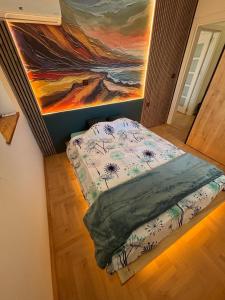 a bed in a room with a painting on the wall at Puro Center in Ohrid
