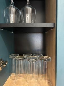 a group of glasses sitting on a shelf at Puro Center in Ohrid +8 photos