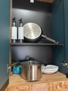 a pot and a whisk on a shelf in a kitchen at Puro Center in Ohrid