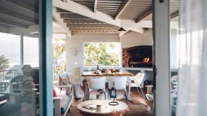 a living room with a table and a fireplace at Authentic Mossel Bay in Mossel Bay