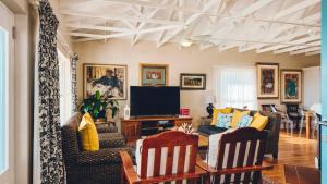 a living room with a couch and a tv at Authentic Mossel Bay in Mossel Bay