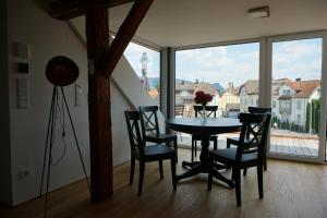 a dining room with a table and chairs and a window at Ferienhaus Ritter in Hard