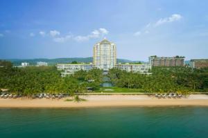 a view of a beach with a resort in the background at The Happy Marina Hotel Phú Quốc - Sunset & Ocean View in Phú Quốc