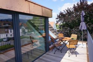 a patio with a table and chairs on a balcony at Ferienhaus Ritter in Hard